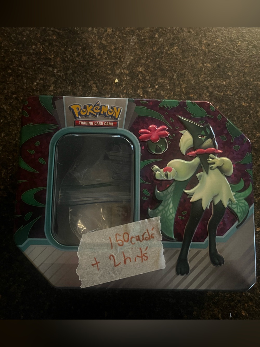 Pokemon Tin Featuring Sprigatito Artwork in Teal and Burgundy